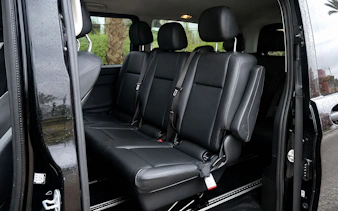 Interior of a private car in Tangier with black leather seats.