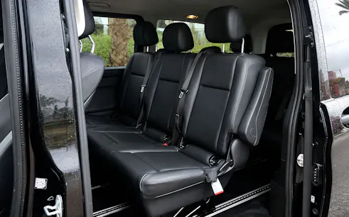 Interior of a private car in Tangier with black leather seats.