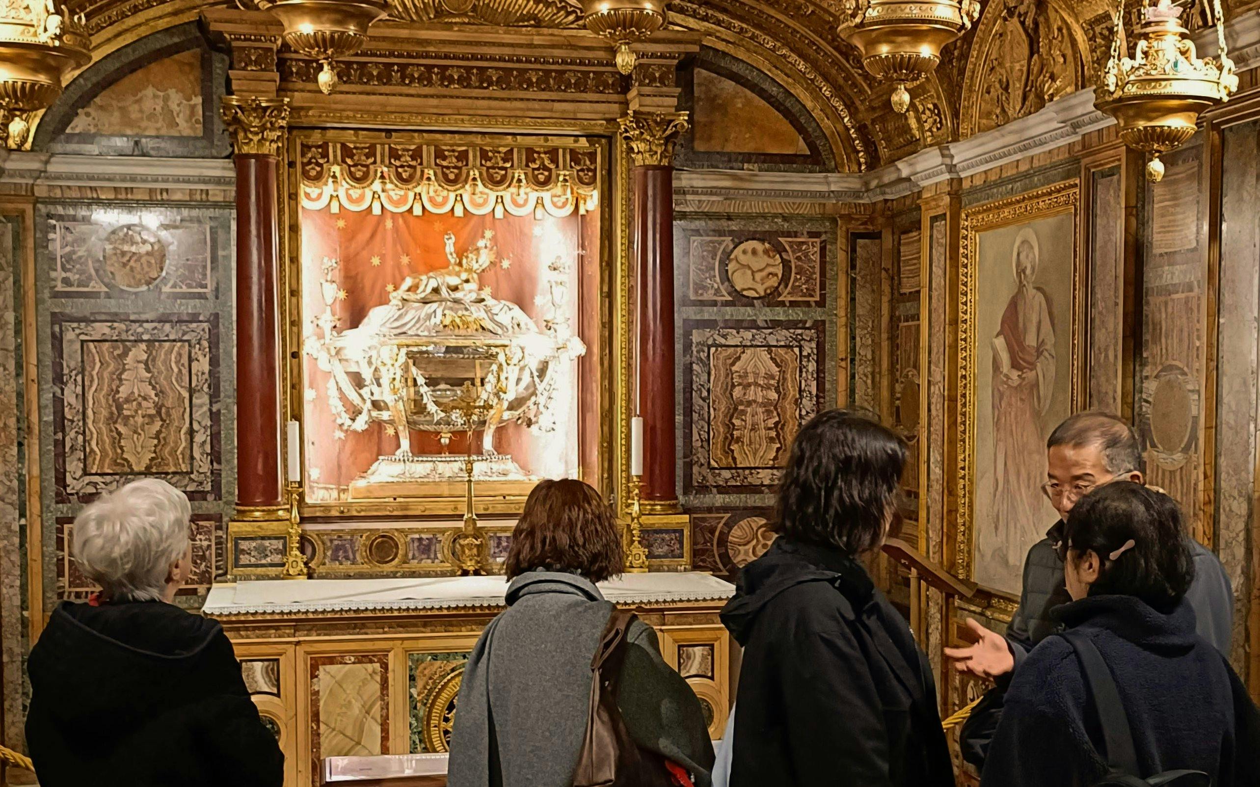 Visitors observing the Reliquary of the Holy Crib inside Basilica of Santa Maria Maggiore, Rome.
