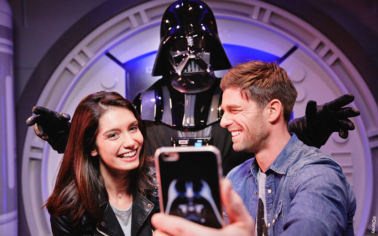 Visitors posing with Darth Vader at Disneyland Paris.