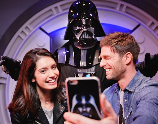Visitors posing with Darth Vader at Disneyland Paris.