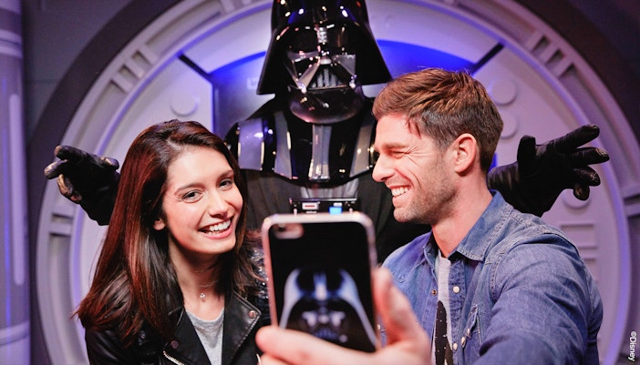 Visitors posing with Darth Vader at Disneyland Paris.
