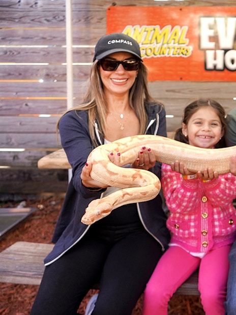 Guests holding a large snake at Everglades Holiday Park animal encounter.