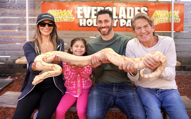 Guests holding a large snake at Everglades Holiday Park animal encounter.