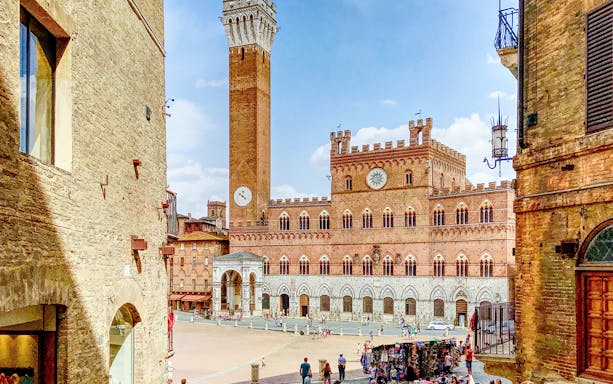 Siena's Piazza del Campo with Torre del Mangia, Italy.