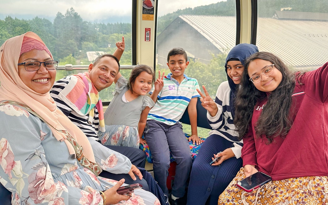 Family enjoying a cable car ride on Mount Fuji and Hakone Premium Tour.