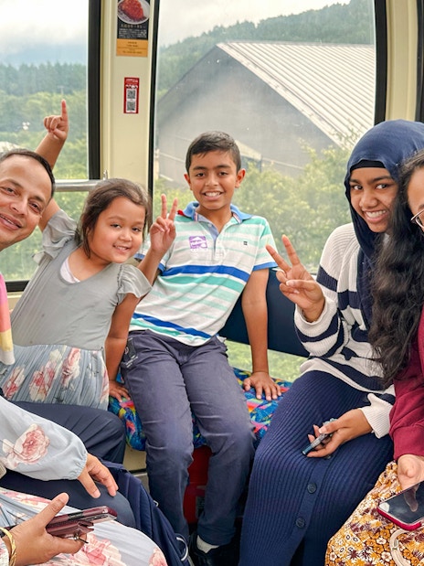 Family enjoying a cable car ride on Mount Fuji and Hakone Premium Tour.