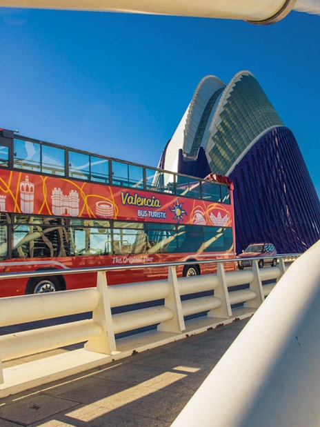Valencia Hop On Hop Off bus crossing a modern bridge near the City of Arts and Sciences.