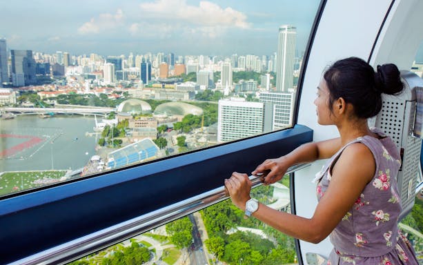 Woman enjoying cityscape from Singapore Flyer, Singapore.