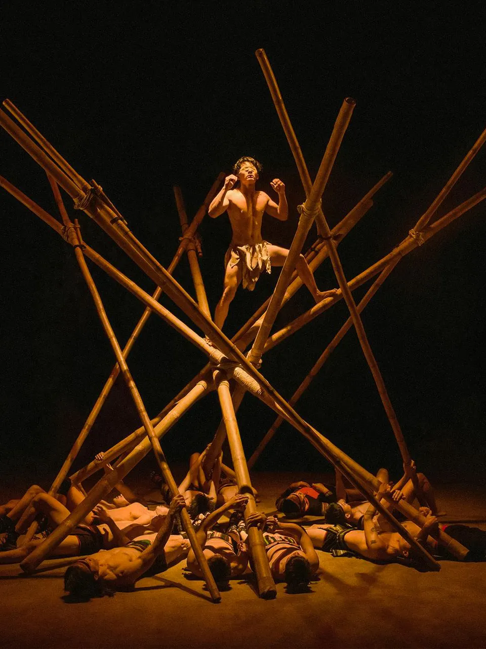 Performer balancing on bamboo structure at Teh Dar: Vietnamese Bamboo Circus.