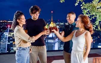 Guests enjoying drinks at Highgarden rooftop lounge, Highline Warsaw with city skyline views.