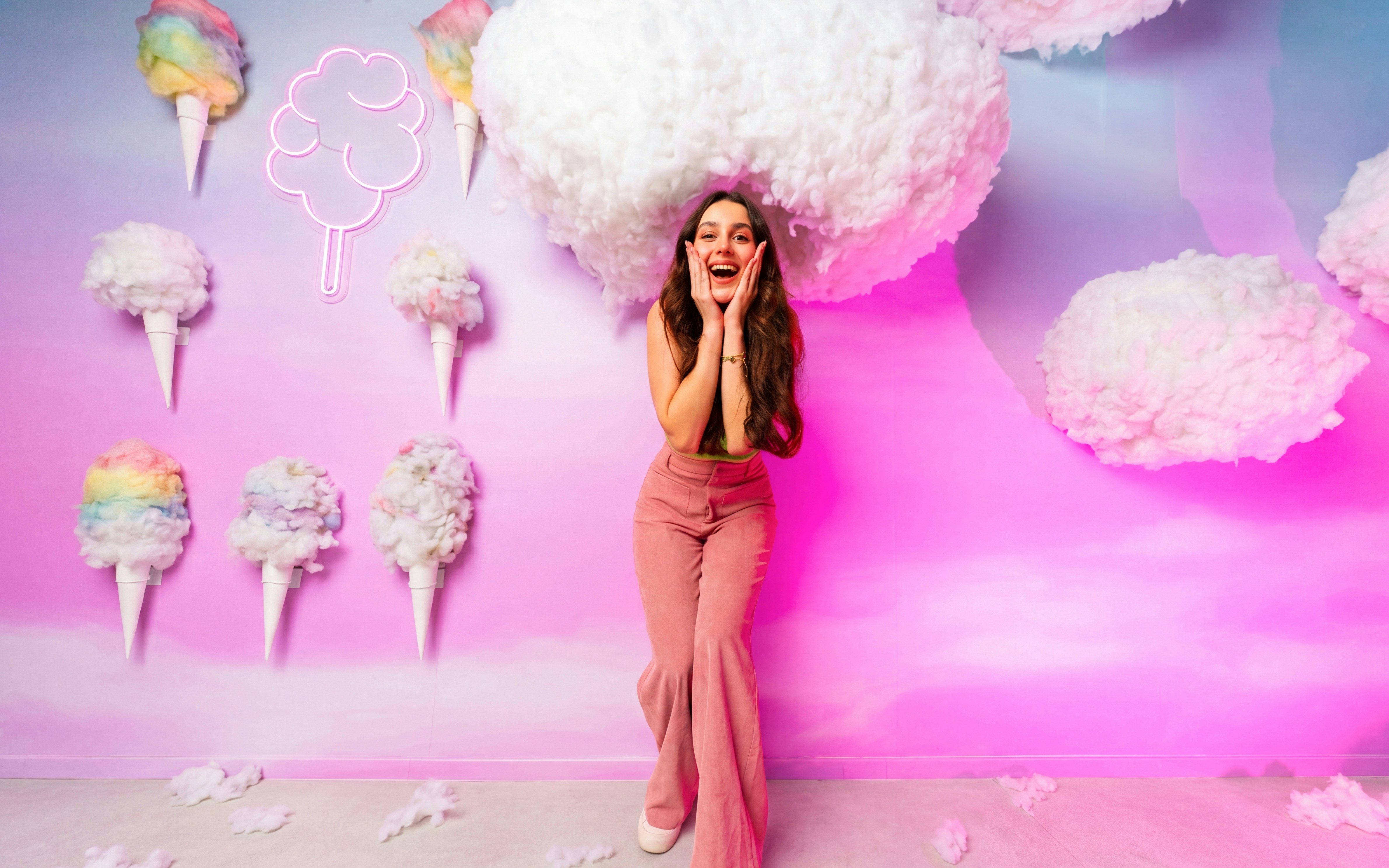 Woman posing with cotton candy decor at Museum of Candy, Dubai.