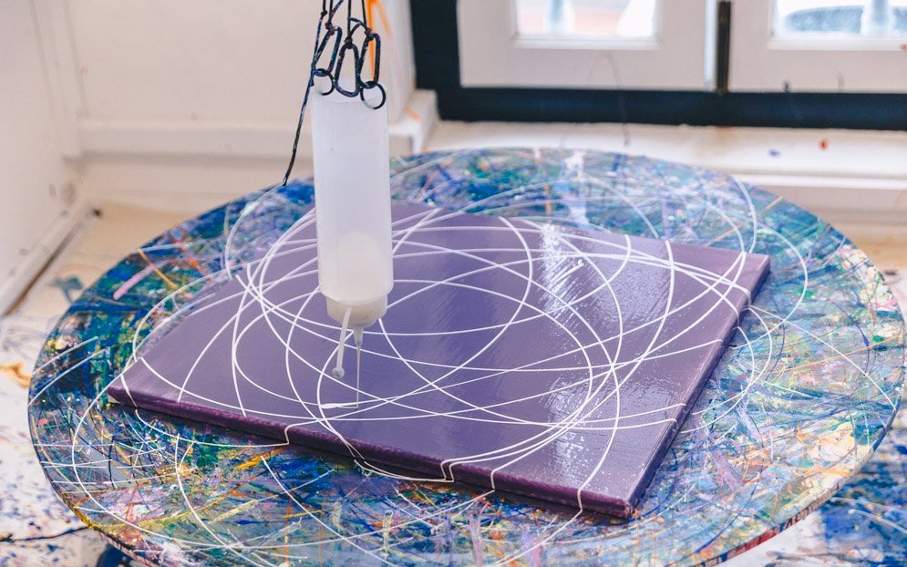 Artwork creation at Motion Art Space Singapore with paint patterns on a spinning canvas.