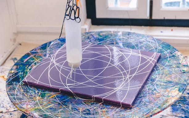 Artwork creation at Motion Art Space Singapore with paint patterns on a spinning canvas.