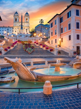 Spanish Steps and Barcaccia Fountain at sunset in Rome, Italy.