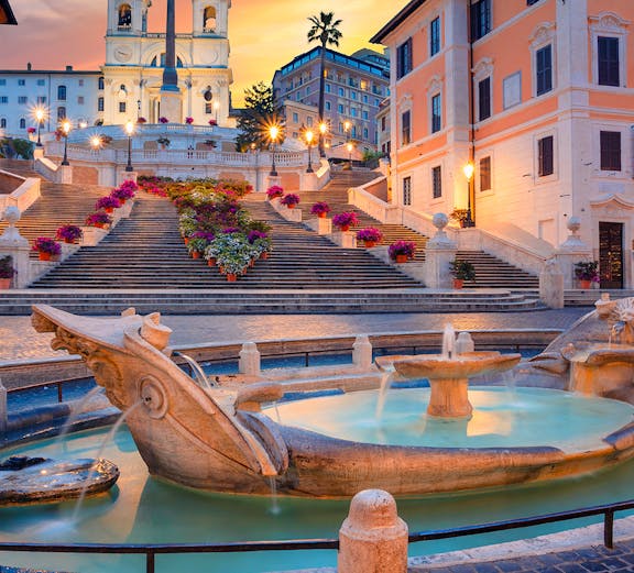 Spanish Steps and Barcaccia Fountain at sunset in Rome, Italy.