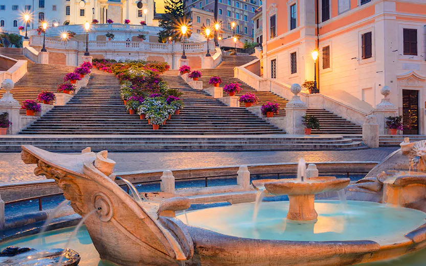 Spanish Steps and Barcaccia Fountain at sunset in Rome, Italy.