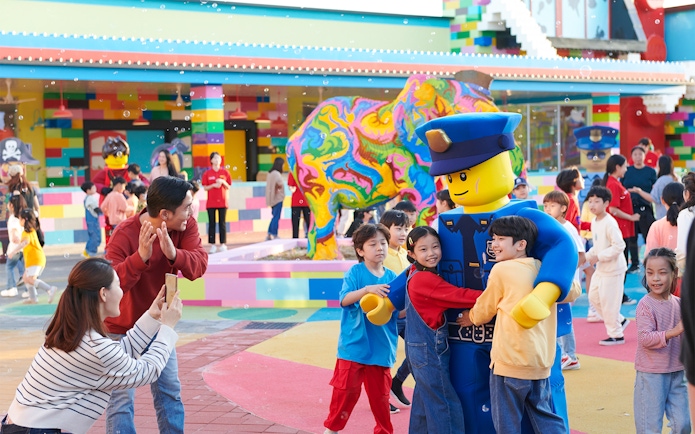 Children hugging a Lego character at Legoland Korea.