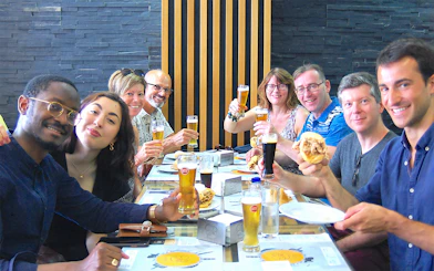 Group enjoying local food and drinks on an Authentic Porto Food & Wine Tour.