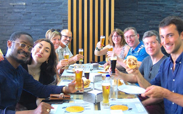 Group enjoying local food and drinks on an Authentic Porto Food & Wine Tour.