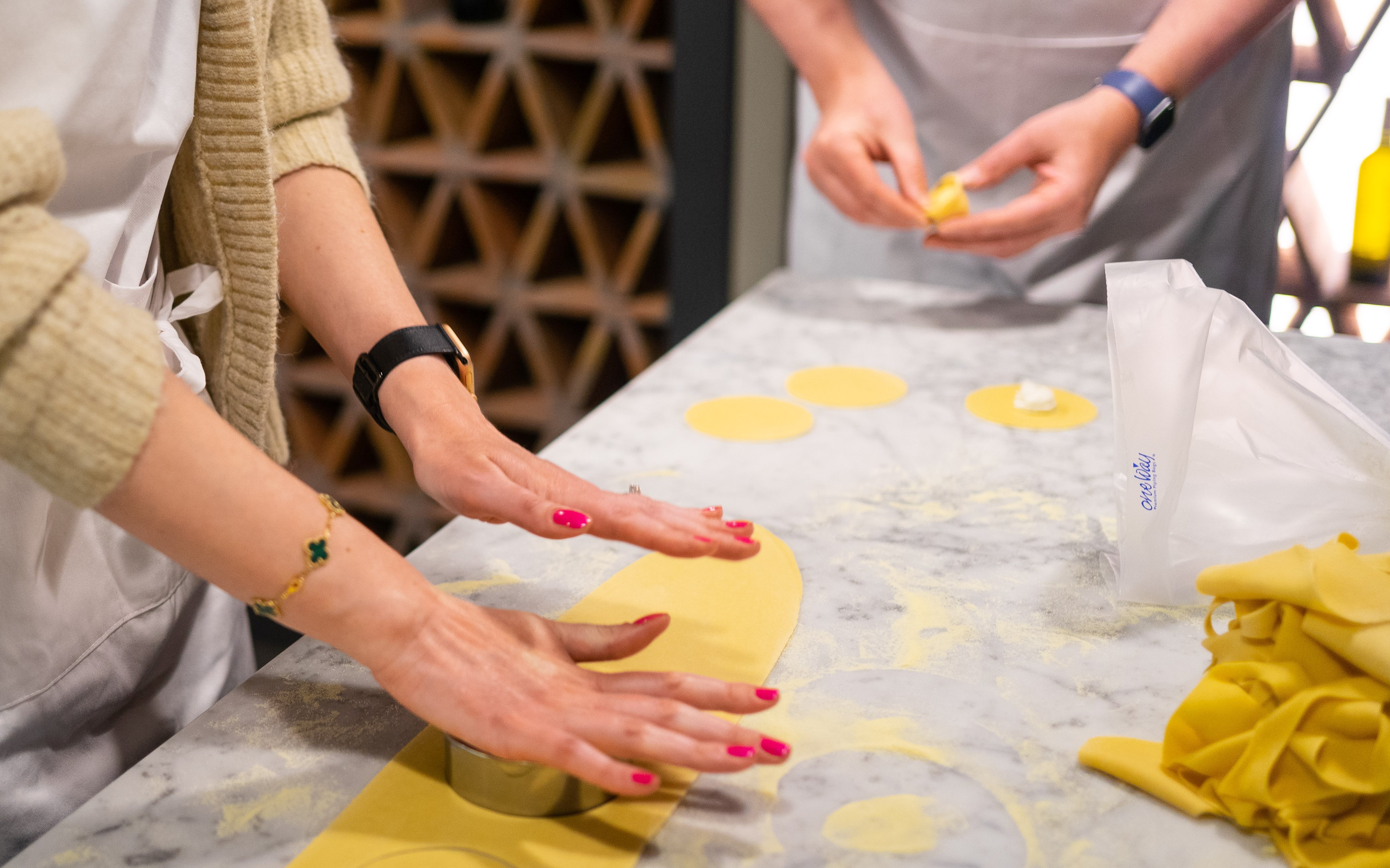 Hands preparing pasta dough during a cooking class in Milan.