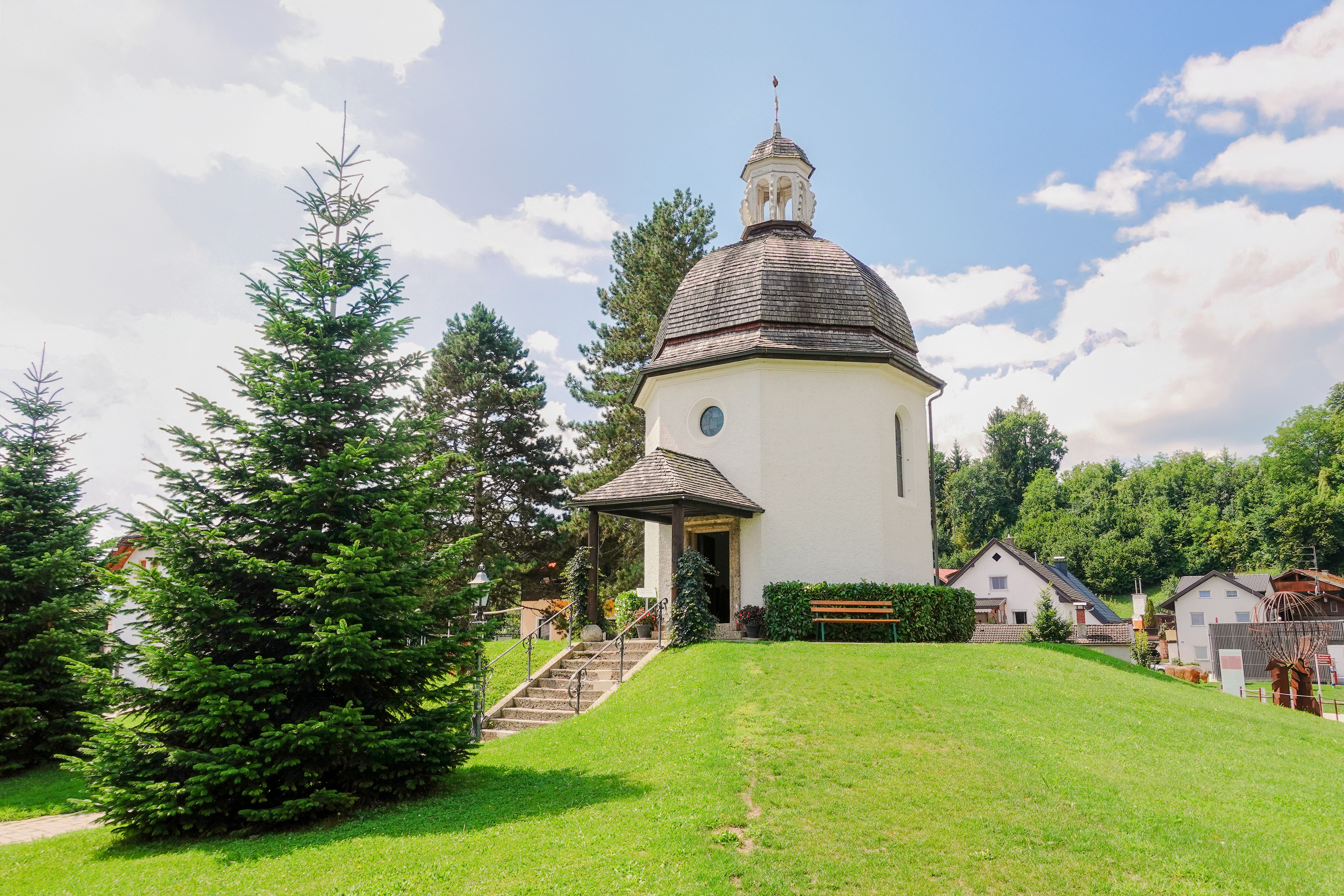 Silent Night Chapel surrounded by trees in Salzburg, Austria.