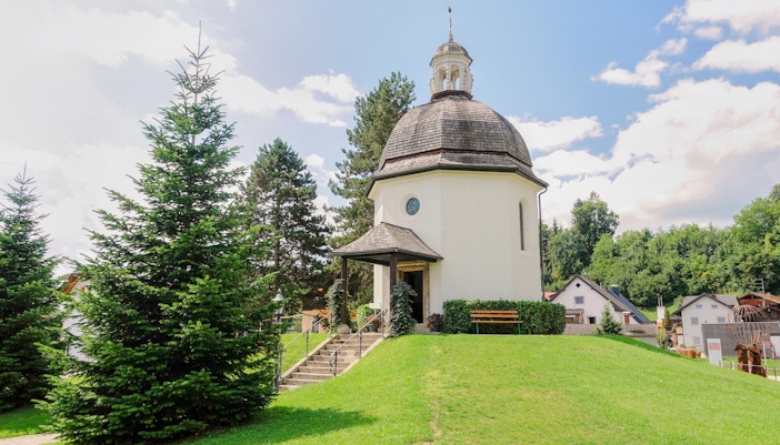 Silent Night Chapel surrounded by trees in Salzburg, Austria.
