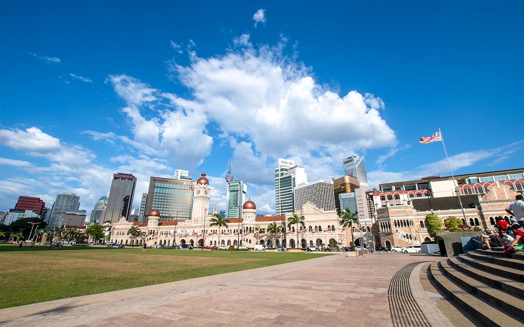 Merdeka Square in Kuala Lumpur with Sultan Abdul Samad Building and city skyline.