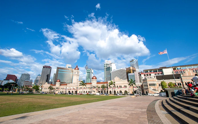 Merdeka Square in Kuala Lumpur with Sultan Abdul Samad Building and city skyline.