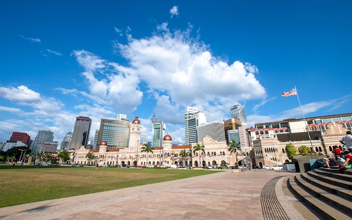 Merdeka Square in Kuala Lumpur with Sultan Abdul Samad Building and city skyline.