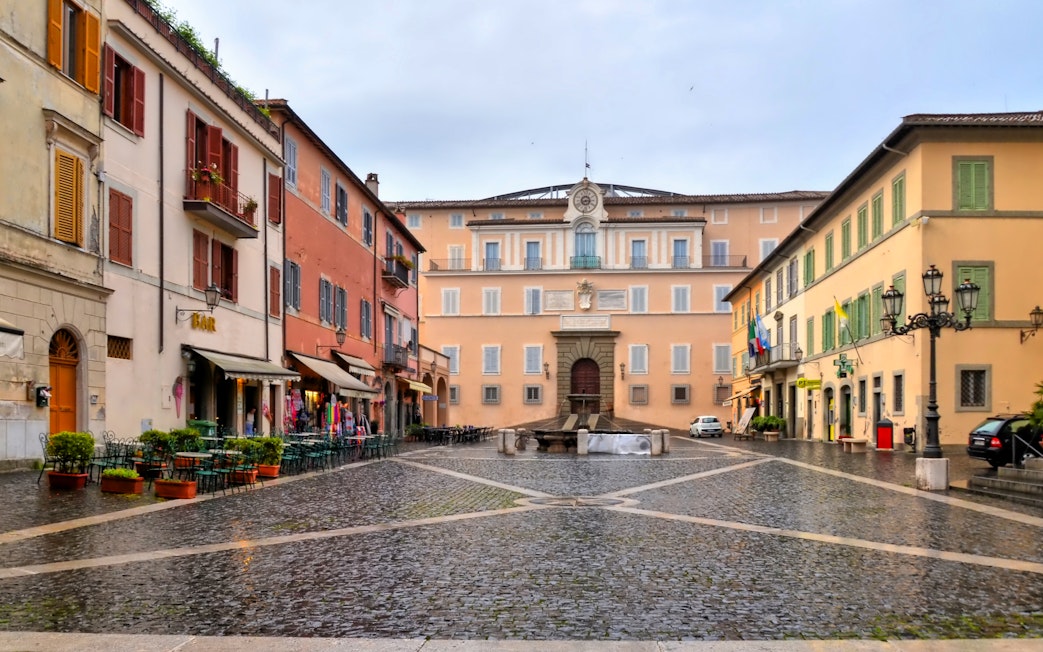 Piazza in front of Castel Gandolfo with cobblestone streets and surrounding buildings.