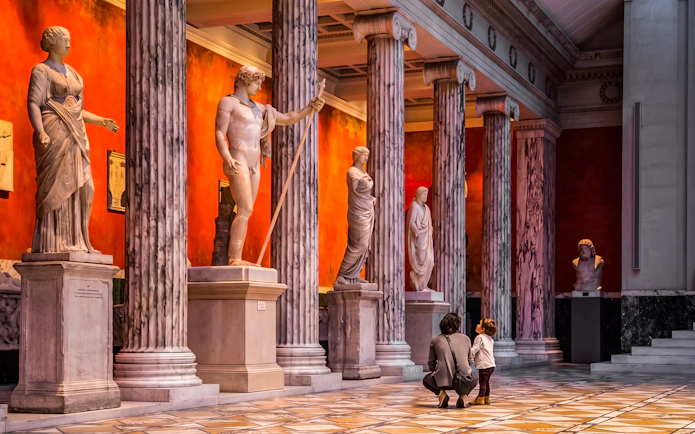 Grand colonnaded hall with statues, Ny Carlsberg Glyptotek, Copenhagen, Denmark.
