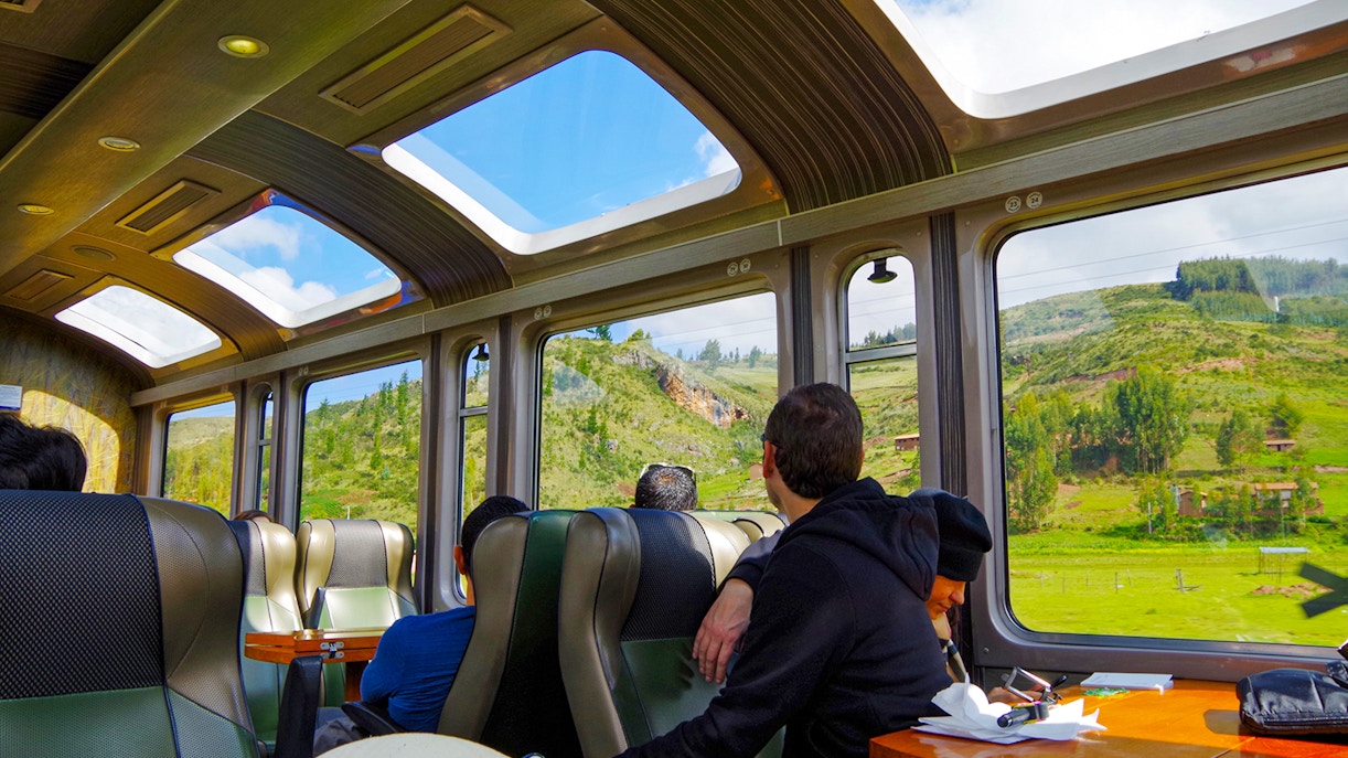 Train passengers viewing scenic landscapes