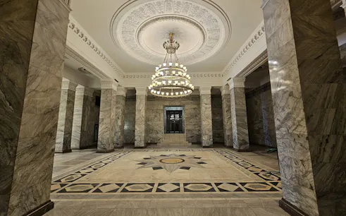 Palace of Culture and Science interior with ornate ceiling and chandelier, Warsaw tour.