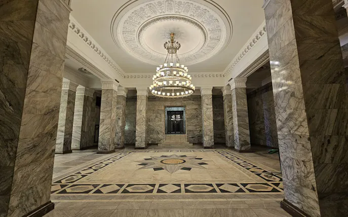 Palace of Culture and Science interior with ornate ceiling and chandelier, Warsaw tour.