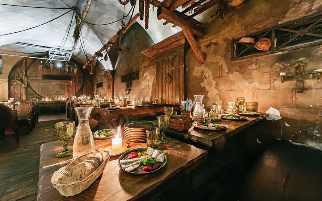 Medieval dining setup with three-course meal in Prague tavern.