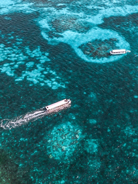 Cruise boats on clear waters near Green Island, Great Barrier Reef, Australia.