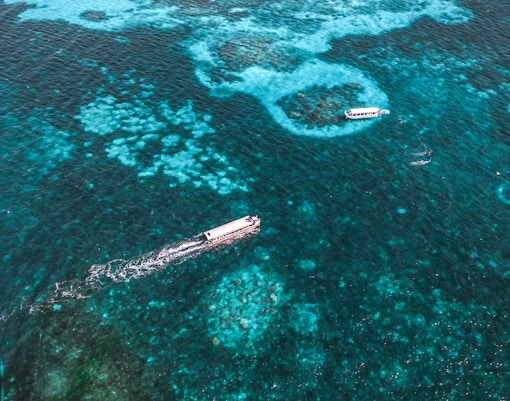 Cruise boats on clear waters near Green Island, Great Barrier Reef, Australia.