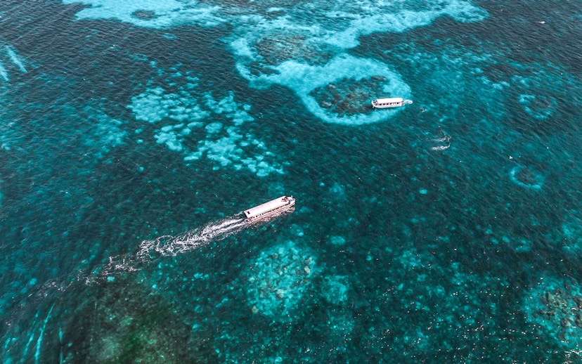 Cruise boats on clear waters near Green Island, Great Barrier Reef, Australia.