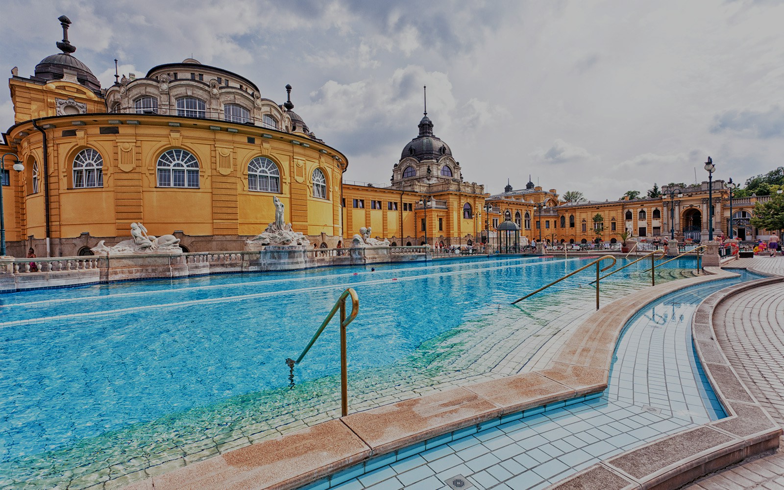 Thermal pools at Budapest baths with people relaxing and enjoying the warm waters.
