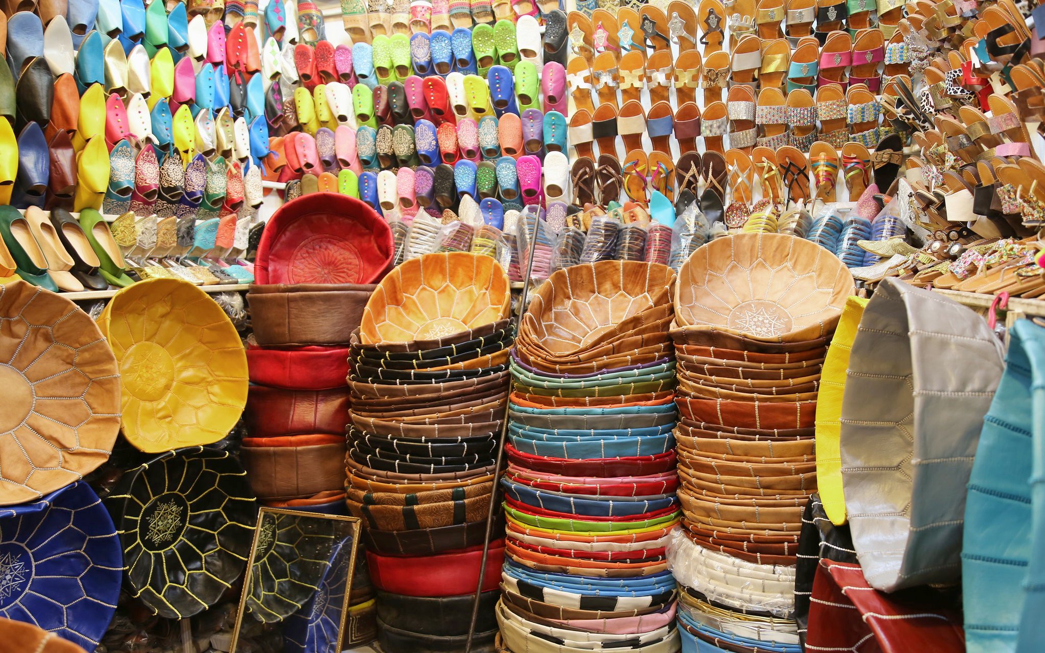 Colorful leather goods and slippers in Marrakech souks near Ben Youssef Medersa.