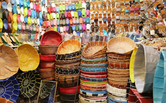 Colorful leather goods and slippers in Marrakech souks near Ben Youssef Medersa.