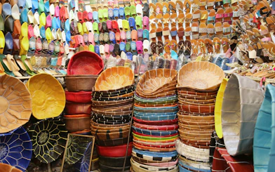 Colorful leather goods and slippers in Marrakech souks near Ben Youssef Medersa.