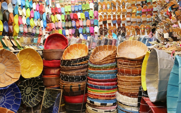 Colorful leather goods and slippers in Marrakech souks near Ben Youssef Medersa.