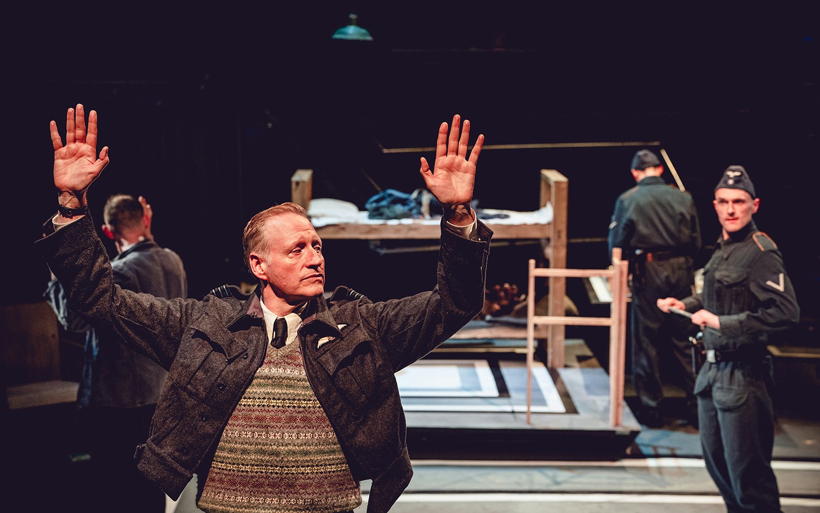 Theatrical scene from "Tom, Dick and Harry" with actors in military uniforms on stage.