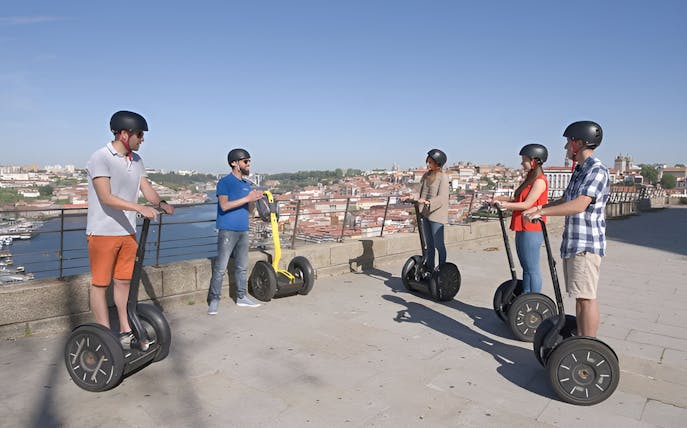 Group on Segways overlooking Porto cityscape during guided tour.