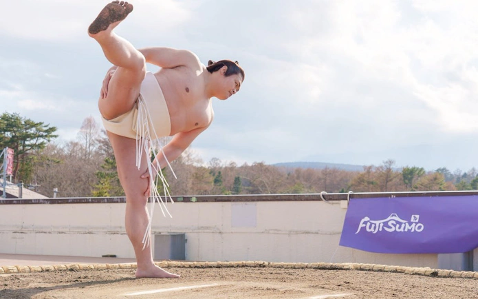 Sumo wrestler performing a warm-up stretch at Fuji Sumo show in Yamanashi, Japan.