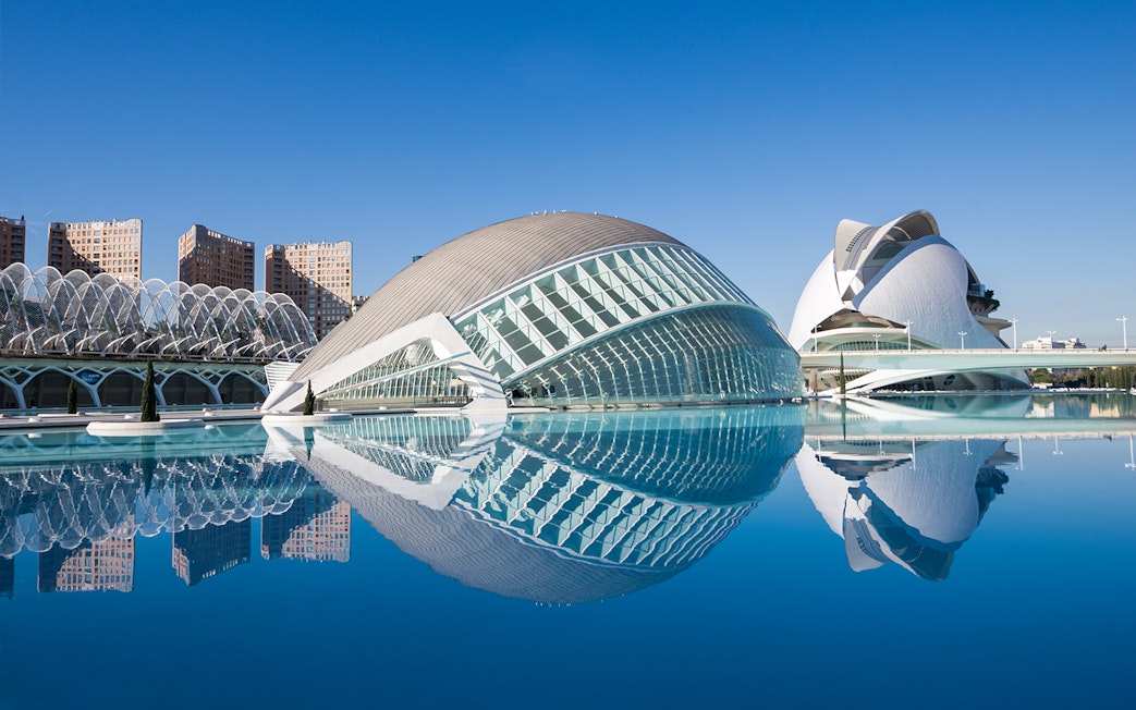 Hemisfèric and Science Museum in Valencia reflected in water.