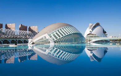 Hemisfèric and Science Museum in Valencia reflected in water.