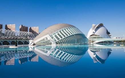 Hemisfèric and Science Museum in Valencia reflected in water.